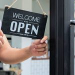 business-owners-hold-an-open-sign-1